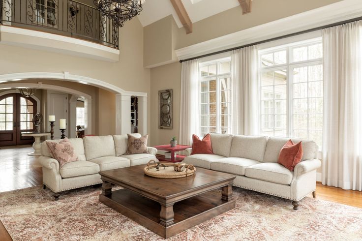 a living room filled with furniture and windows