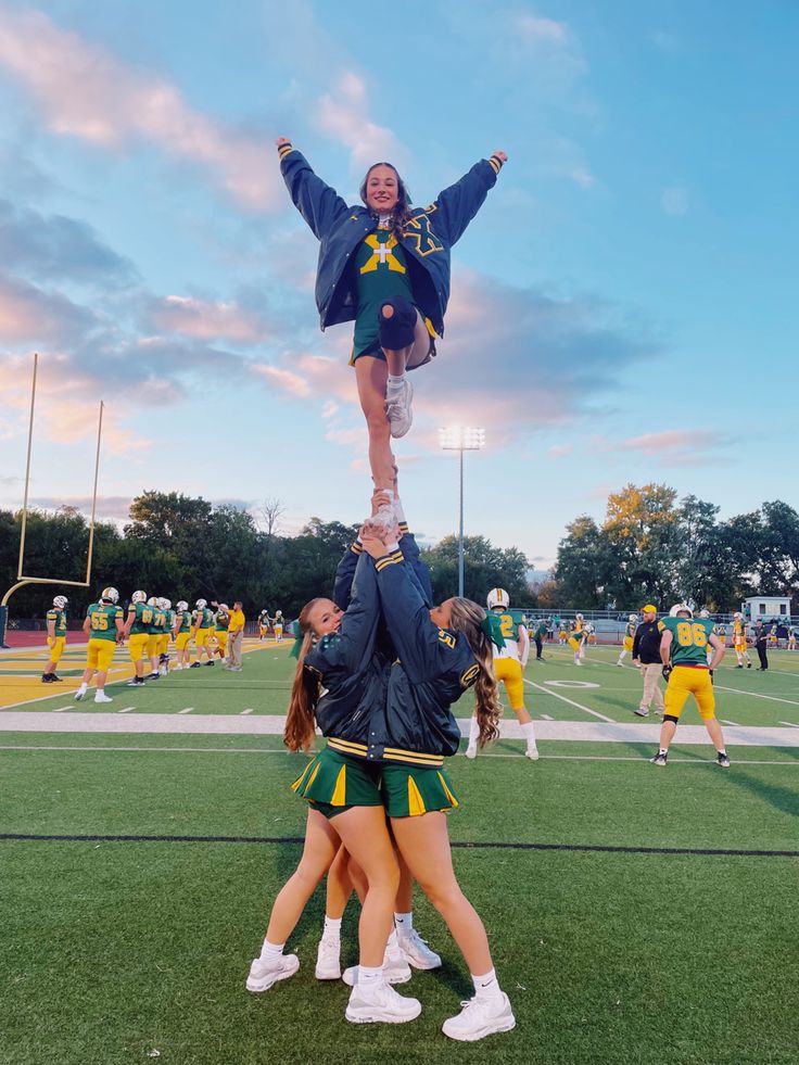 the cheerleaders are doing tricks on the field