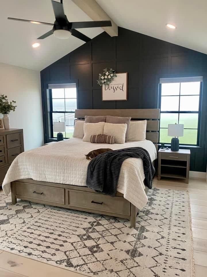 a bedroom with a bed, dresser and ceiling fan in it's center area