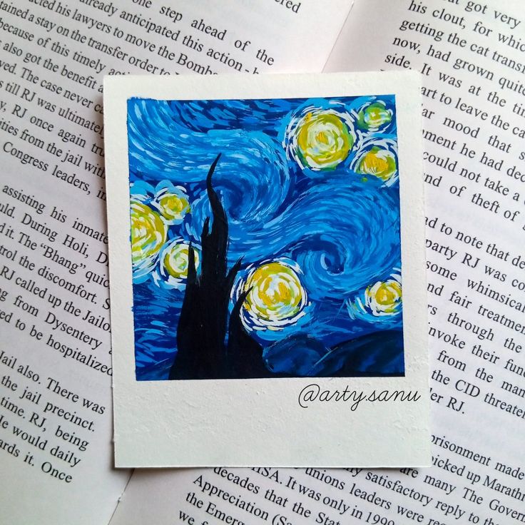 the starry night painting is on top of an open book