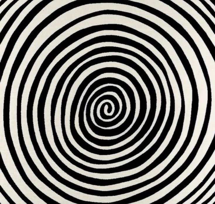 an abstract black and white pattern with spirals in the center, as if it was made out of paper