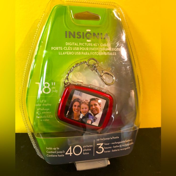 a red and green case with a key chain attached to it, in the packaging