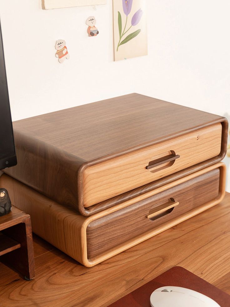 a computer monitor sitting on top of a wooden desk next to a mouse and keyboard