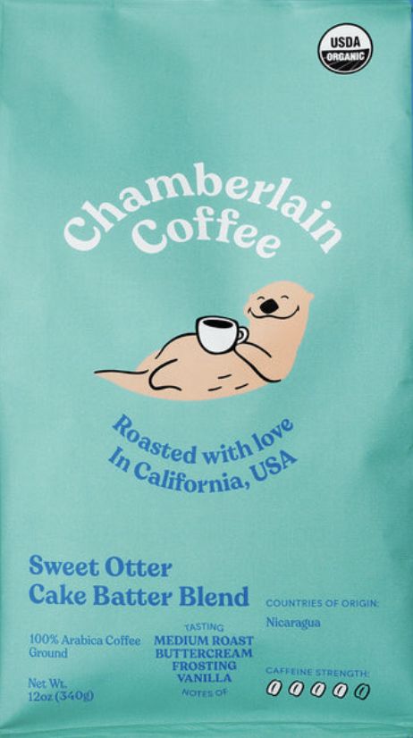 a bag of coffee sitting on top of a blue tablecloth with the words, chamberlain coffee roasted with love in california usa