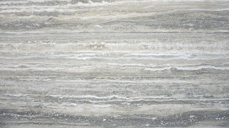 a close up view of a marble floor with grey and white stripes on it's surface