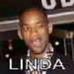 a man making a face while standing in front of a sign with the words lindaa on it