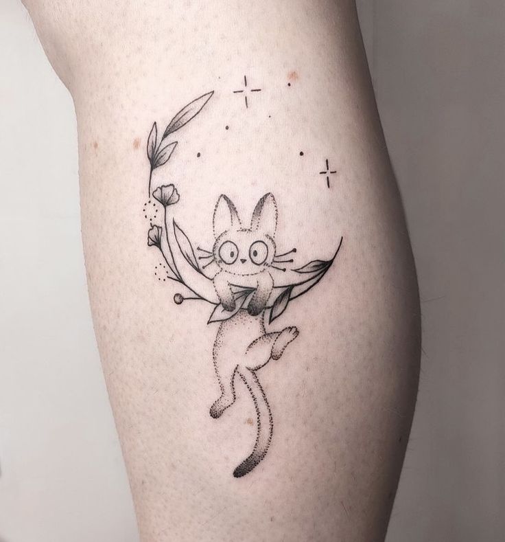 a woman's thigh with a cartoon character on it and an arrow in the middle