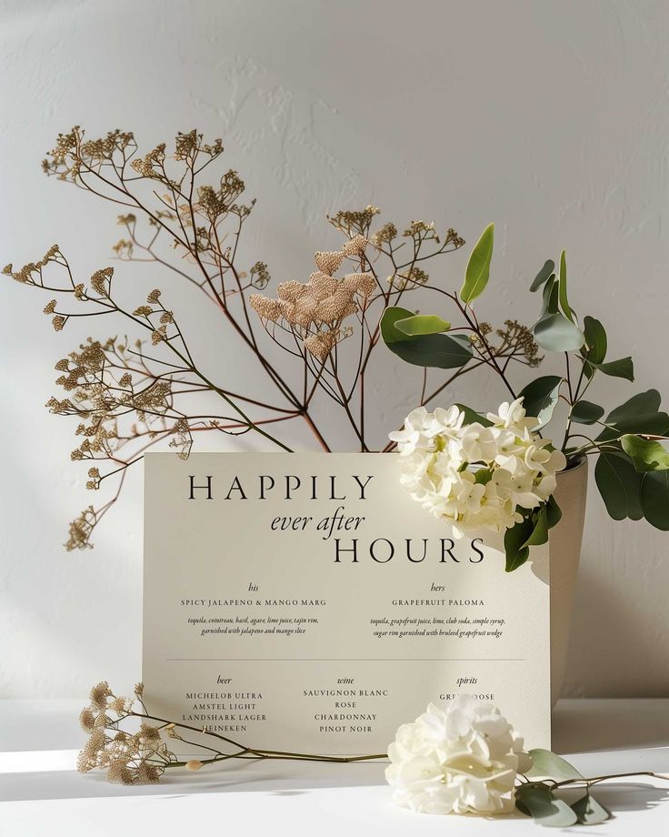 a vase filled with white flowers next to a sign that says happily every hours