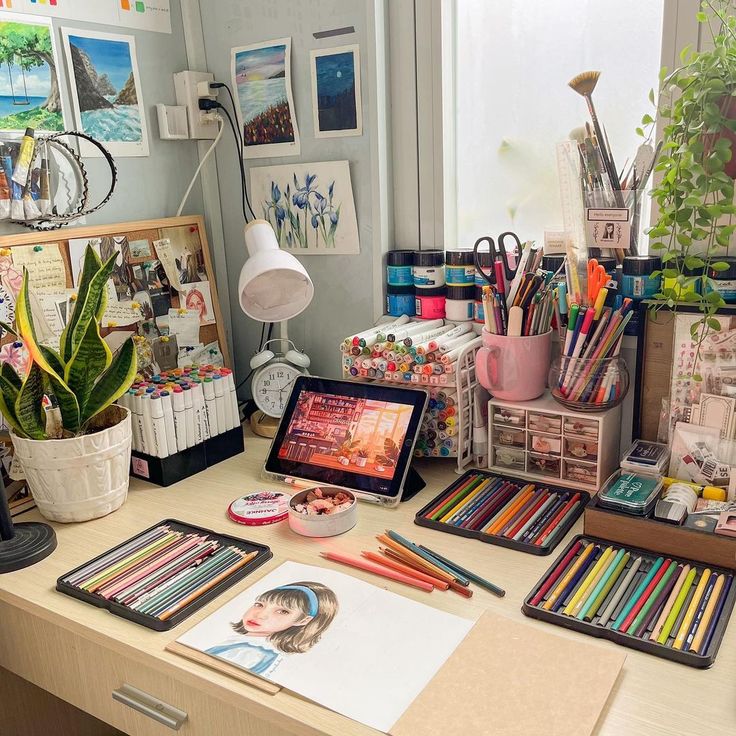 the desk is full of art supplies and office supplies