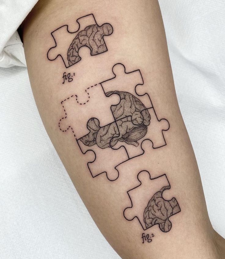 a person with a tattoo on their arm has two pieces missing from the same puzzle piece