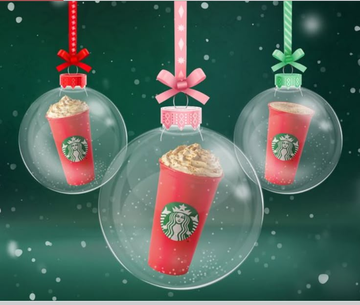 three christmas ornaments with starbucks drinks hanging from the top and bows on each ornament