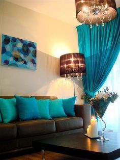 the living room is decorated in teal and brown