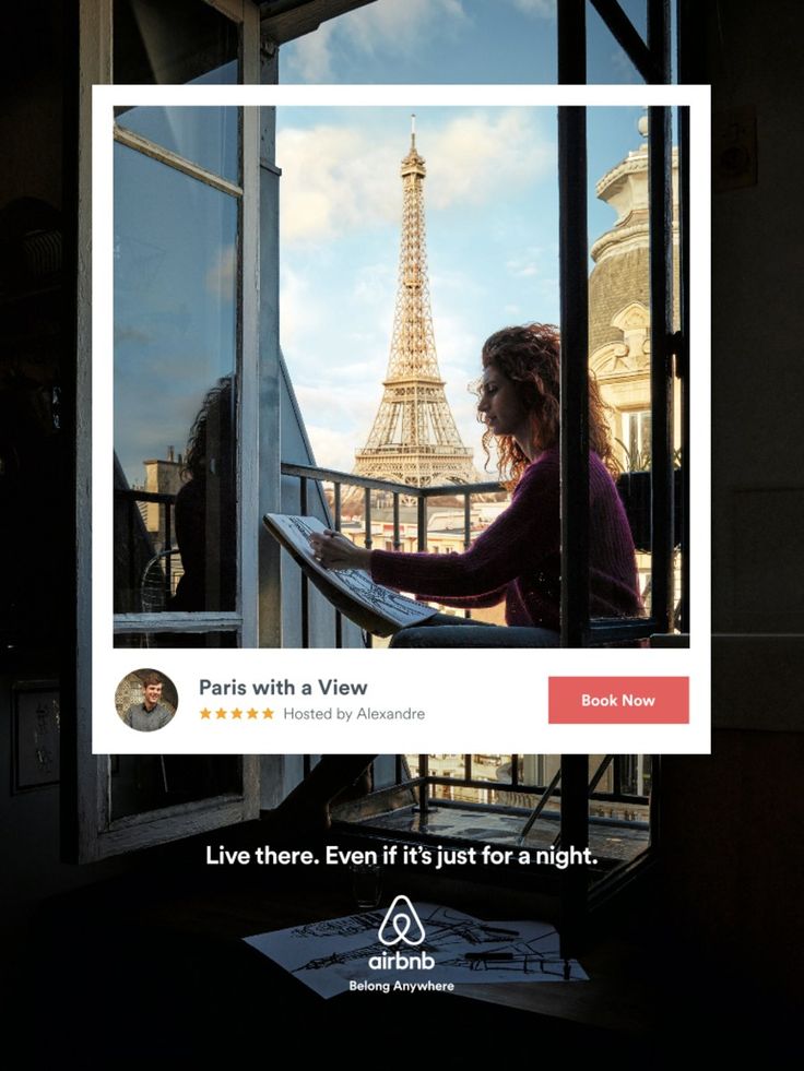 a woman is looking out the window at the eiffel tower