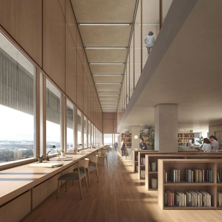 an empty library with lots of bookshelves and people sitting at the desks