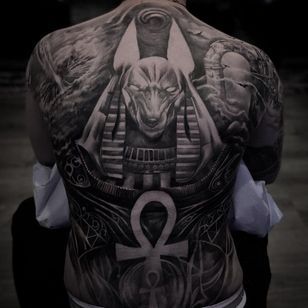 the back of a man with an egyptian tattoo