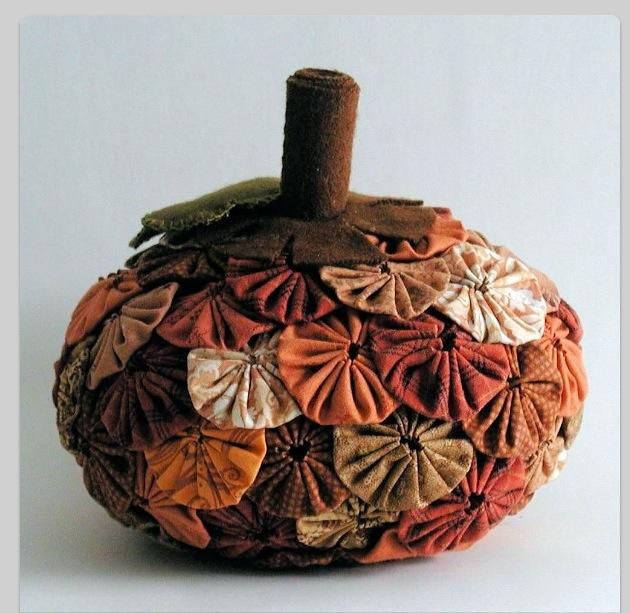 an orange and brown pumpkin with leaves on it