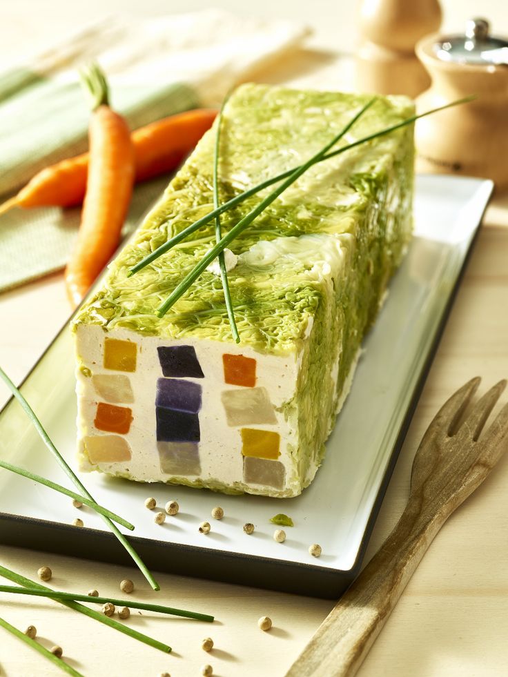 a piece of cake sitting on top of a plate next to carrots and celery