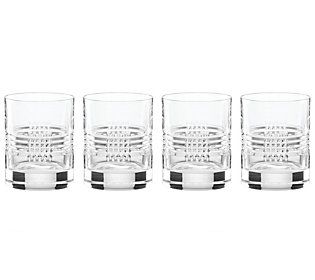 four glasses are lined up next to each other