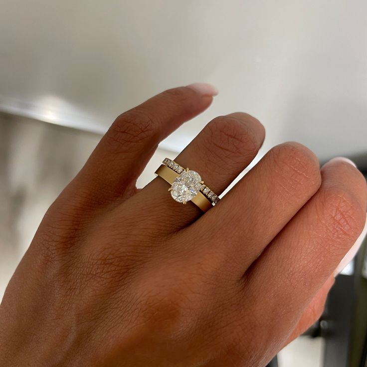 a woman's hand with a diamond ring on it