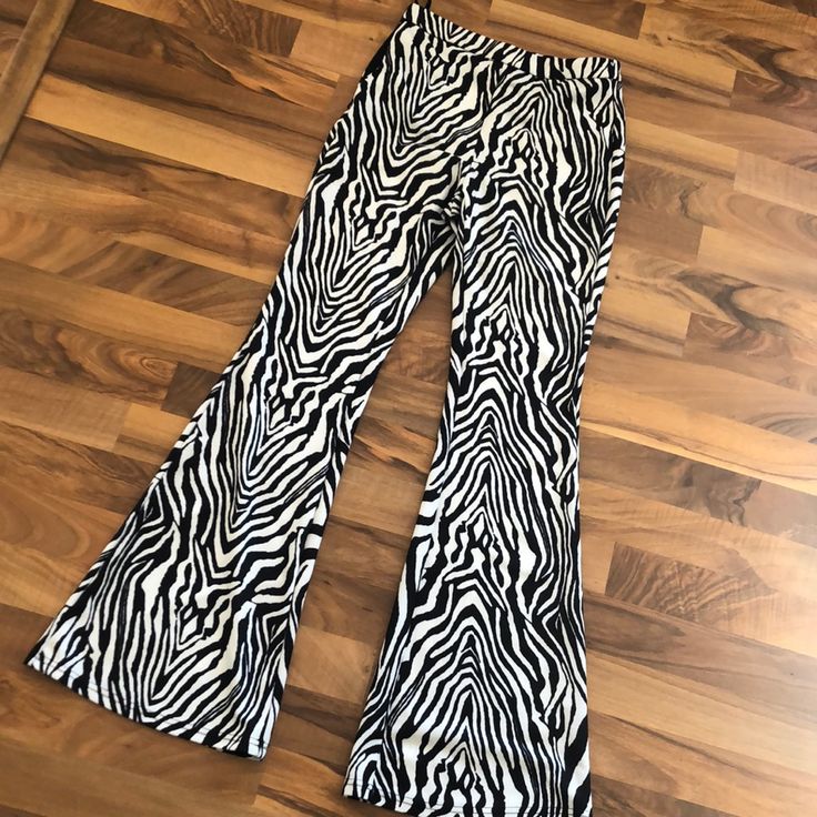 Never Worn Zebra Print Flare Pants. Zipper And Tie Waist. Stretch Zebra Print Bottoms For Summer, Casual Fitted Bottoms With Zebra Print, Casual Fitted Zebra Print Bottoms, White Stretch Bottoms With Zebra Print, White Stretch Zebra Print Bottoms, White Zebra Print Stretch Bottoms, Casual Stretch Zebra Print Bottoms, Casual Black Zebra Print Pants, Black Zebra Print Bottoms For Spring