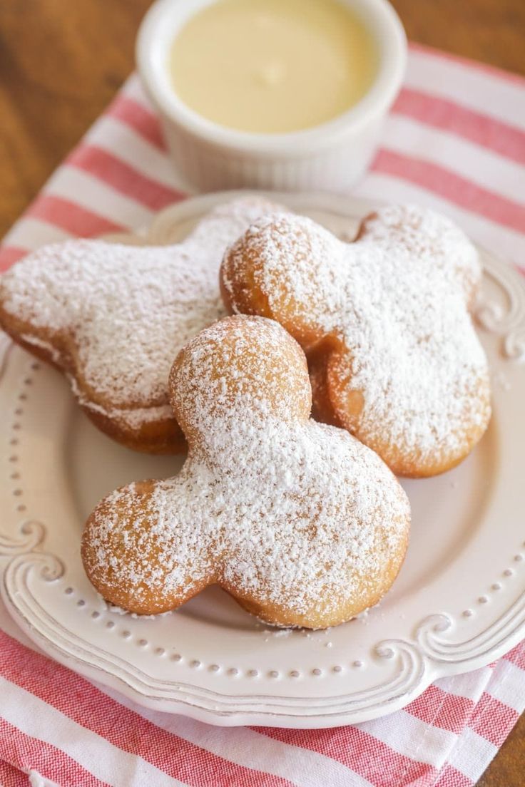 powdered sugar cookies on a plate with a cup of coffee