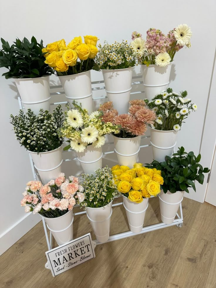 a bunch of flowers that are sitting on a shelf