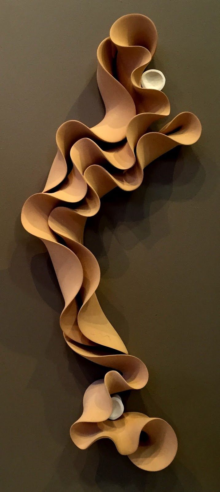 a sculpture made out of paper on the wall