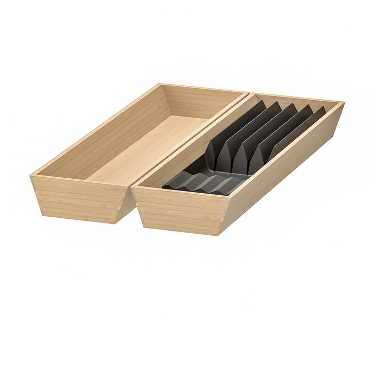 an open wooden drawer with black plates in it