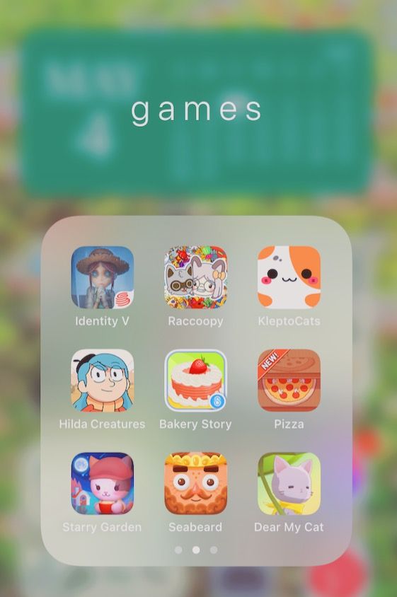 an iphone screen with the game icons displayed on it's back side, and text that reads games