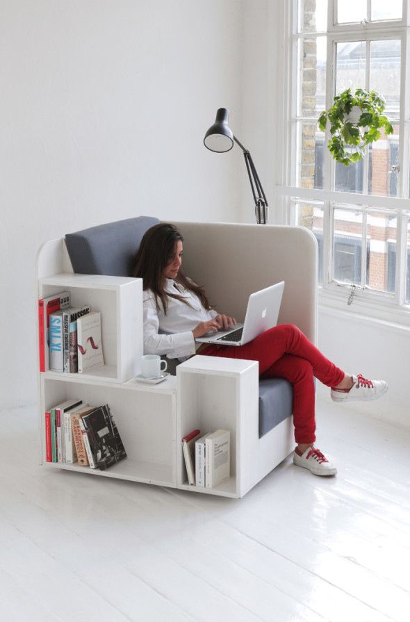 a woman sitting in a chair using a laptop computer