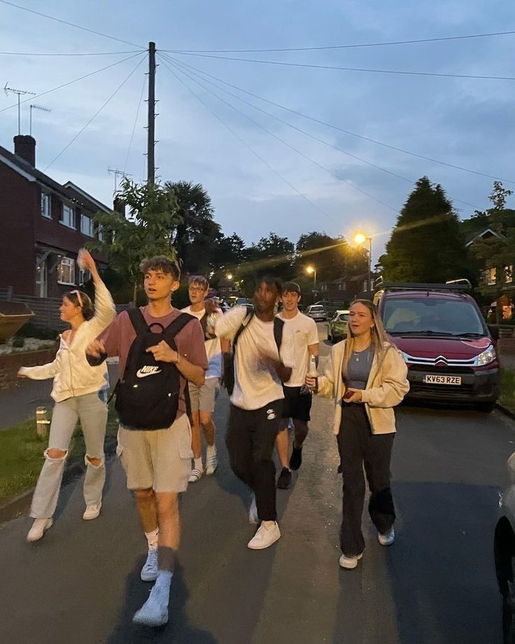 a group of young people walking down a street