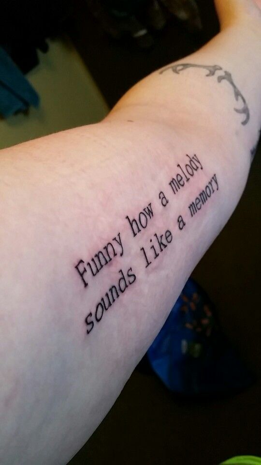 a person with a tattoo that says funny how a melon sounds like memory on their arm