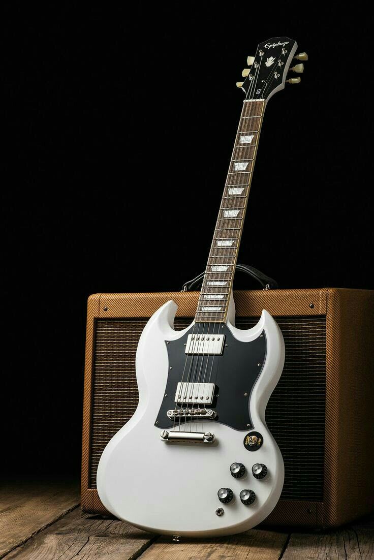 an electric guitar sitting on top of a wooden table