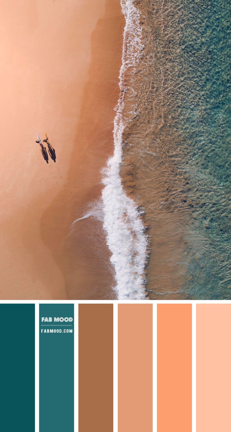 an aerial view of the beach with two people on surfboards in the water and sand