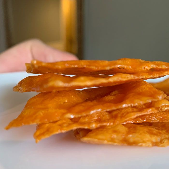 a white plate topped with cheetos on top of a table