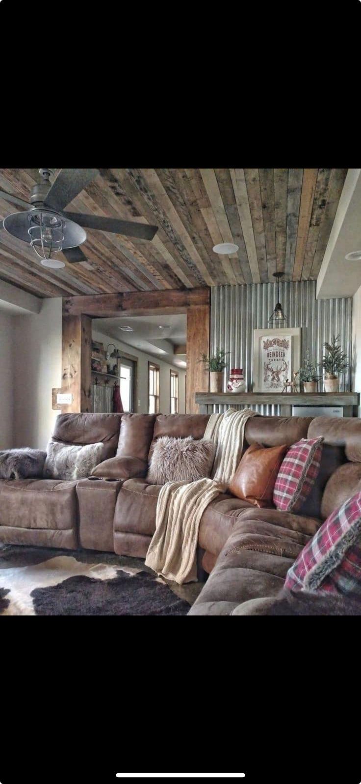 a living room filled with lots of furniture and pillows on top of carpeted flooring