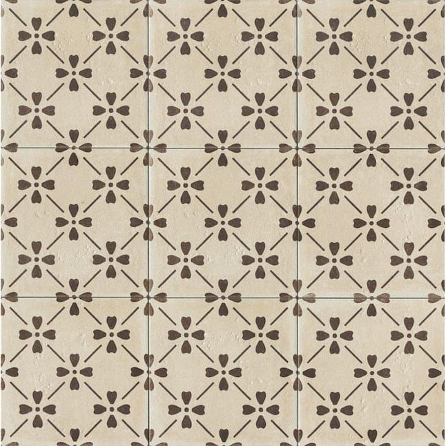 a white and brown tile pattern with small black flowers on the bottom half of it