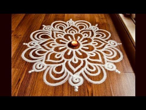 a wooden floor with a white doily on top of it and a candle in the middle