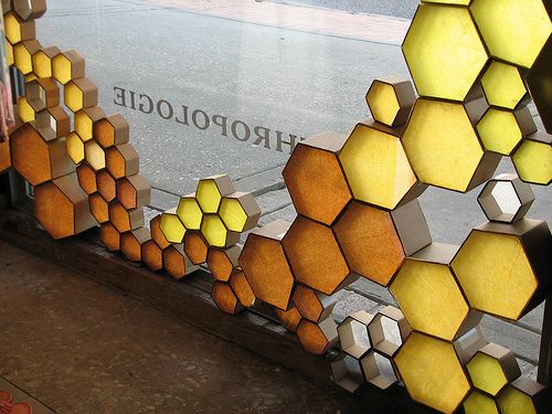 an artistic display in front of a store window with hexagons on it