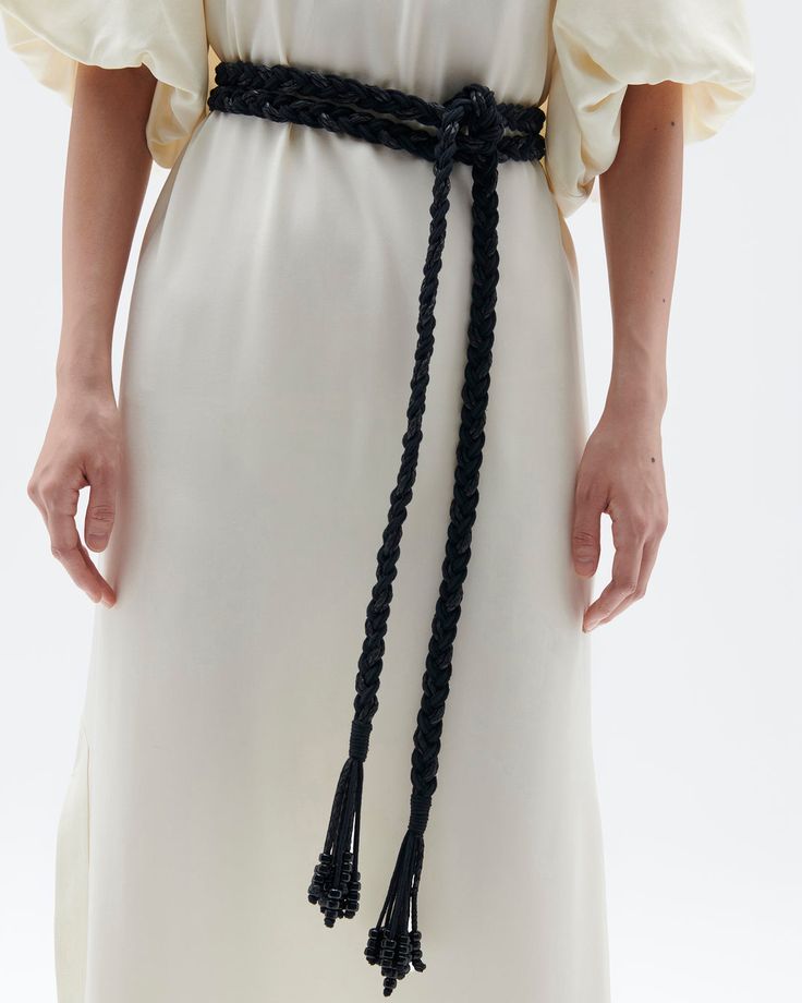 Woven leather is braided seamlessly into cotton cords that wrap effortlessly around your waist and finishes with a wrapped beaded tassel. Wraparound closure Length: 104” Width: ¾” Cotton + Leather Braided Fabric, Scarf Designs, Night Tops, Black Ombre, Fall 23, Black Chevron, Braided Belt, Fabric Belt, Accessories Handmade