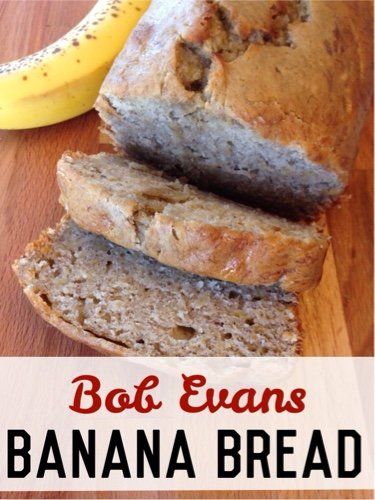 banana bread sliced and sitting on top of a wooden cutting board next to a banana