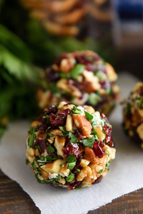 three cookies with nuts and cranberries on top