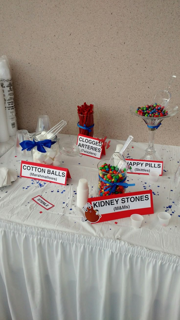 the table is set up with candy, cotton balls and other items for an event