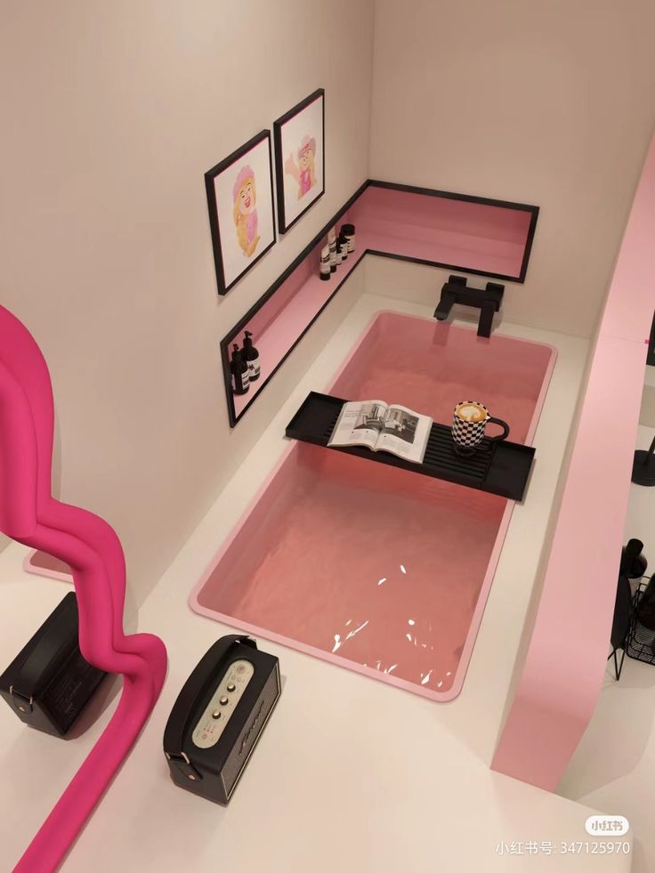 a room with pink furniture and pictures on the wall, including a table that has an open book in it