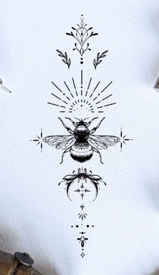 a drawing of a bee on top of a piece of paper with some scissors next to it