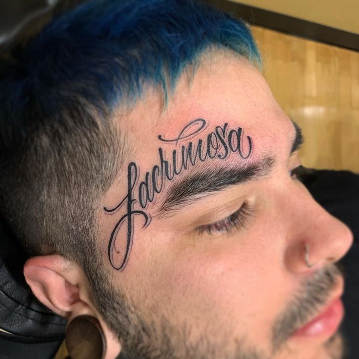 a man with blue hair has the word falchusosa written on his forehead