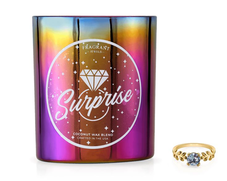 a ring sits next to a cup with the word surprise on it and an image of a diamond