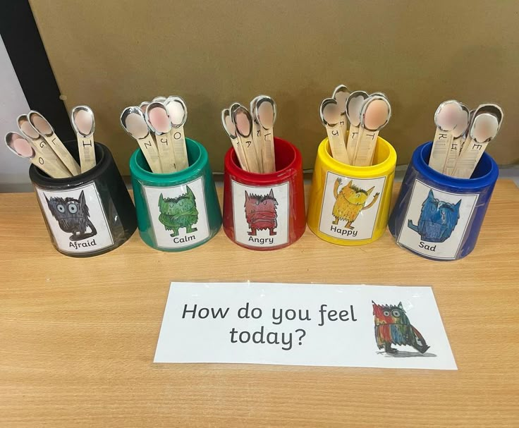 a group of small cups with spoons in them on a table next to a sign that says how do you feel today?