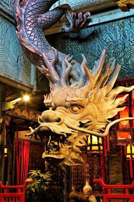 a dragon statue sitting in the middle of a room