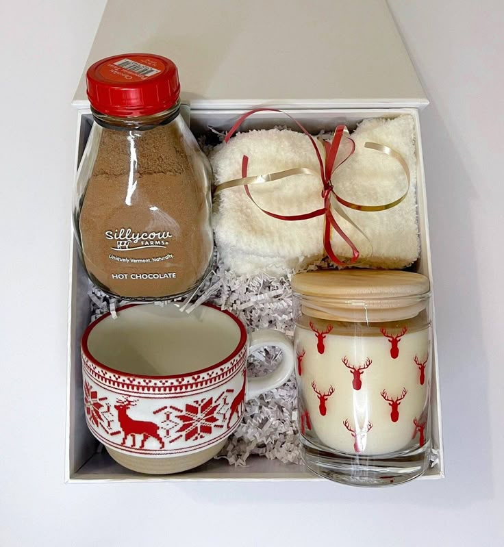 an open box containing two mugs, cookies, and other items to make christmas gifts